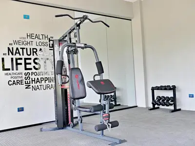 a gym with a treadmill and a chair in a room at Acogedor y Familiar in Colorado