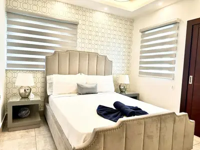 a bedroom with a large bed with a large headboard at Con Estilo Soha II in Colorado