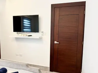 a wooden door in a room with a tv at Con Estilo Soha II in Colorado