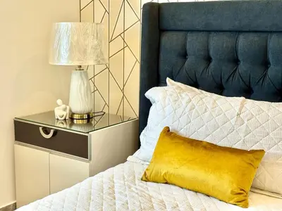 a bed with a yellow pillow and a lamp on a night stand at Con Estilo Soha II in Colorado