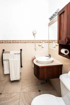 a bathroom with a sink and a toilet at Agualina Kite Hotel in Cabarete