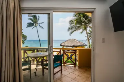 a room with a balcony with a view of the ocean at Agualina Kite Hotel in Cabarete