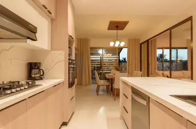 a kitchen with white countertops and a dining room at Villa Privada + Piscina | Playa & Golf in Punta Cana