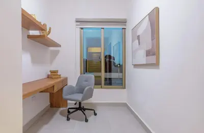 a desk and a chair in a room with a window at Villa Privada + Piscina | Playa & Golf in Punta Cana