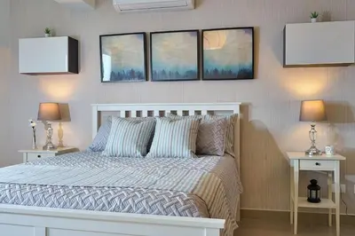 a bedroom with a bed with three pictures on the wall at Erasmo in Colorado