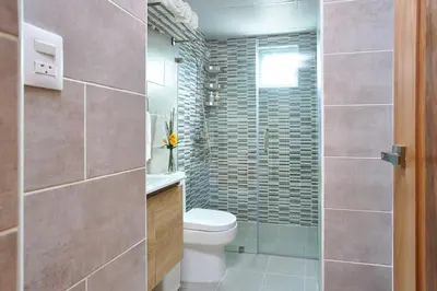 a bathroom with a toilet and a glass shower at Erasmo in Colorado