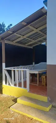 a picnic table under a roof on a patio at Nido de amor in Jarabacoa