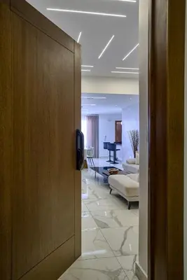 a door leading to a living room with a piano at Lovely 3 Bedroom Apartment, Pool,Gym,2parking S in Santo Domingo