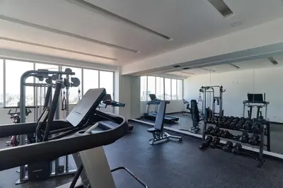 a gym with treadmills and machines in a building at Lovely 3 Bedroom Apartment, Pool,Gym,2parking S in Santo Domingo