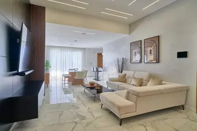 a living room with a couch and a table at Lovely 3 Bedroom Apartment, Pool,Gym,2parking S in Santo Domingo