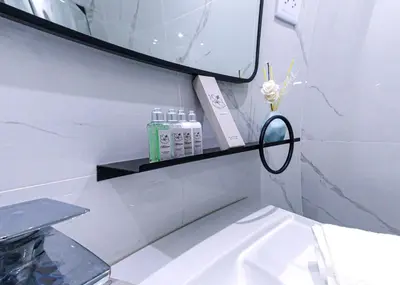 a white bathroom with a mirror and a sink at Hotel la Saladilla Beach Club in Santa Cruz de Barahona