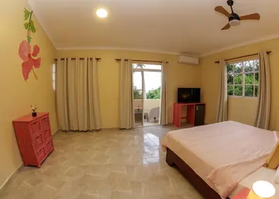 a bedroom with a bed and a ceiling fan at Hotel la Saladilla Beach Club in Santa Cruz de Barahona