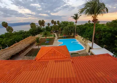 an overhead view of a swimming pool with an orange roof at Hotel la Saladilla Beach Club in Santa Cruz de Barahona