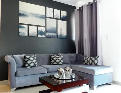 a living room with a blue couch and a table at Aparta Plus 4th Nivel in Colorado