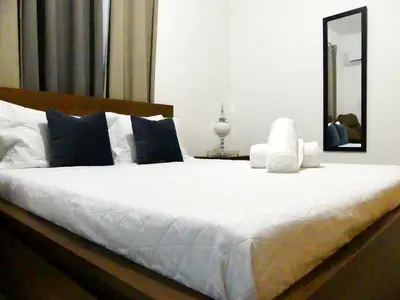 a bedroom with a large white bed with a mirror at Aparta Plus 4th Nivel in Colorado