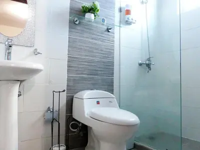 a bathroom with a toilet and a sink and a shower at Aparta Plus 4th Nivel in Colorado
