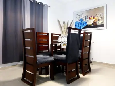 a dining room table with four chairs and a table with ahibition at Aparta Plus 4th Nivel in Colorado