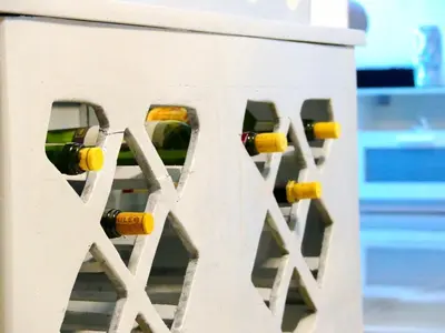 a row of wine bottles in a white building at Aparta Plus 4th Nivel in Colorado