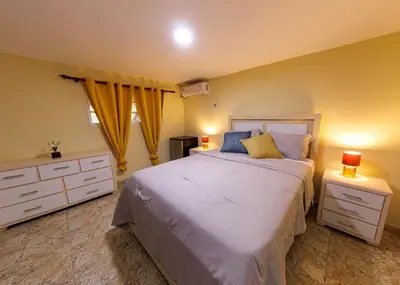 a bedroom with a bed with two night stands and two lamps at Hotel la Saladilla Beach Club in Santa Cruz de Barahona