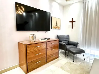 a living room with a tv and a chair at Villa Olga Premium in Colorado