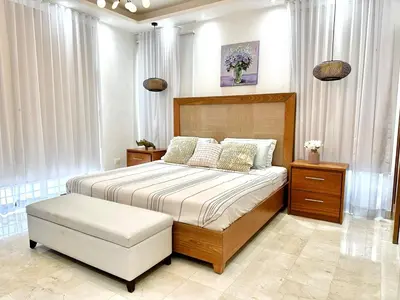 a bedroom with a large bed with a ottoman at Villa Olga Premium in Colorado