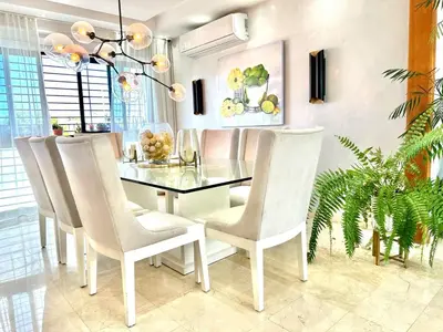 a dining room with a glass table and white chairs at Villa Olga Premium in Colorado
