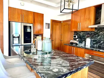 a kitchen with a granite counter top and wooden cabinets at Villa Olga Premium in Colorado