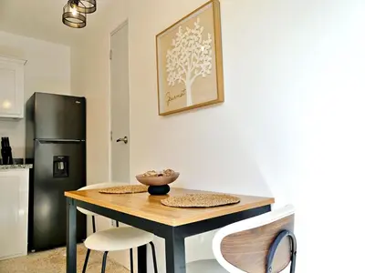 a kitchen with a table and two chairs and a refrigerator at Mini Hogar 4 in Colorado