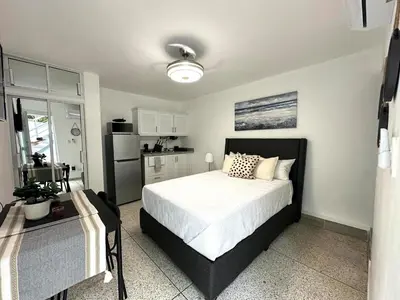 a bedroom with a large bed and a kitchen at Mini Hogar 2 in Colorado
