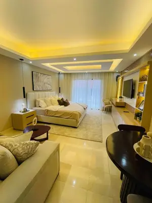a large room with a bed and a living room at Marien Residences 305 Deluxe High Floor Condo in Puerto Plata