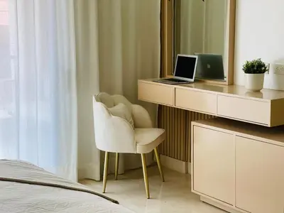 a bedroom with a desk with a laptop and a chair at Marien Residences 305 Deluxe High Floor Condo in Puerto Plata