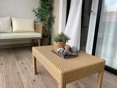 a wicker coffee table in a living room with a couch at Marien Residences 305 Deluxe High Floor Condo in Puerto Plata
