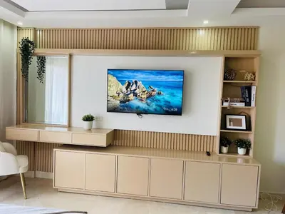 a living room with a tv on a wall at Marien Residences 305 Deluxe High Floor Condo in Puerto Plata