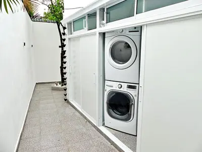 a washer and dryer sitting next to a wall at Mini Hogar 3 in Colorado