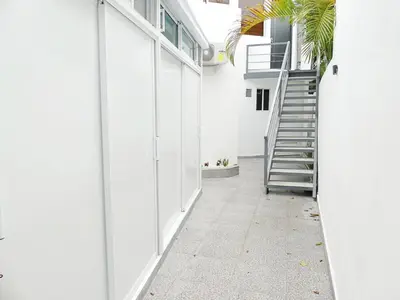 a hallway of a white house with a staircase at Mini Hogar 3 in Colorado