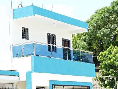 a blue and white house with a balcony at Vista Central in Colorado
