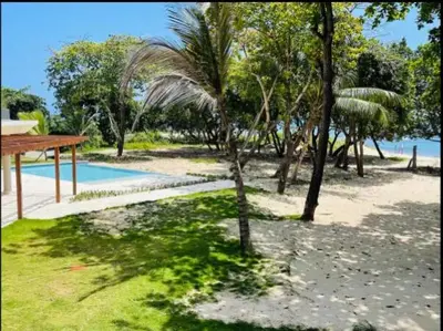 a resort with a palm tree and a pool at Marien Residences 222 Gardenview Condo in Puerto Plata