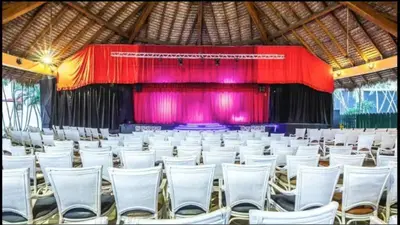 a large auditorium with white chairs and a stage at Marien Residences 222 Gardenview Condo in Puerto Plata