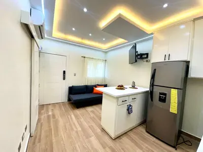 a kitchen with a refrigerator and a couch in a room at Luperon Cerca del Mar in Colorado