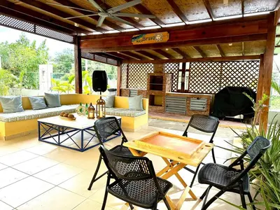 a patio with chairs and a table and a couch at Luperon Cerca del Mar in Colorado