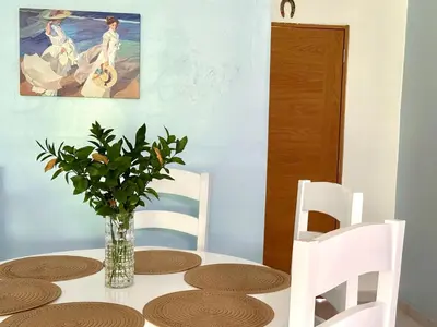 a dining room table with a vase of flowers on it at Cofresi, Puerto Plata in Colorado