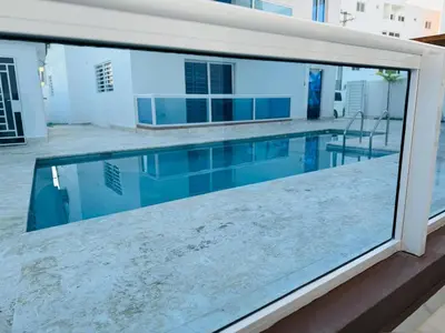 a view of a swimming pool from a balcony at Modern Apartment in Bayahibe in Bayahibe