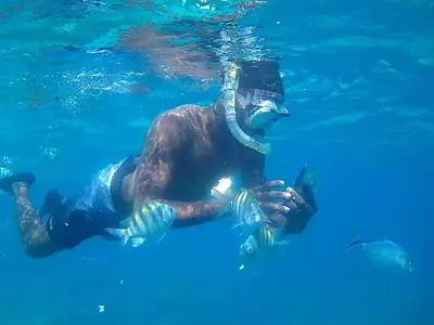 a man is in the water in the water at Modern Apartment in Bayahibe in Bayahibe