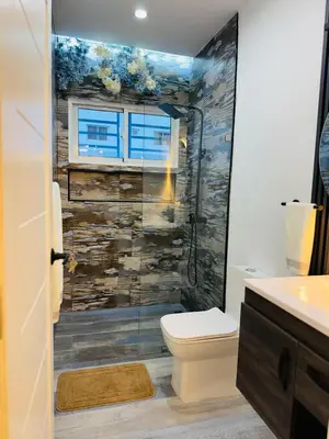 a bathroom with a shower with a toilet and a window at Modern Apartment in Bayahibe in Bayahibe