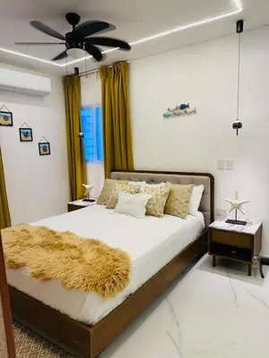 a bedroom with a large bed with a brown blanket at Modern Apartment in Bayahibe in Bayahibe