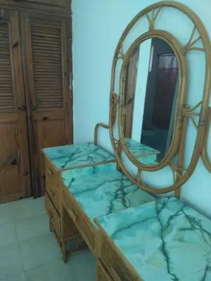 a mirror sitting on top of a wooden dresser at One bedroom apartment in the center with a pool in Sosúa