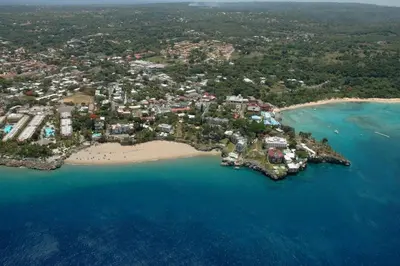 an aerial view of a resort on a beach at One bedroom apartment in the center with a pool in Sosúa