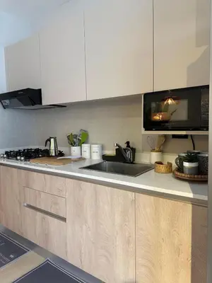 a kitchen with a sink and a microwave at Garden Breeze Ghibli-Pool View in La Laguna