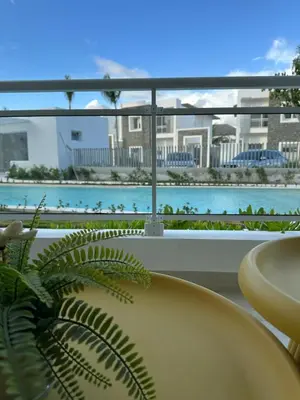 a balcony with a view of a pool in a resort at Garden Breeze Ghibli-Pool View in La Laguna