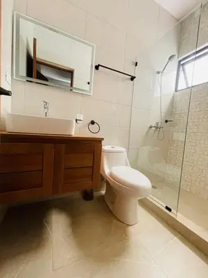 a bathroom with a toilet and a sink and a shower at Sunset Residences 3BR, Pool & Beach Cosita Rica in Puerto Plata